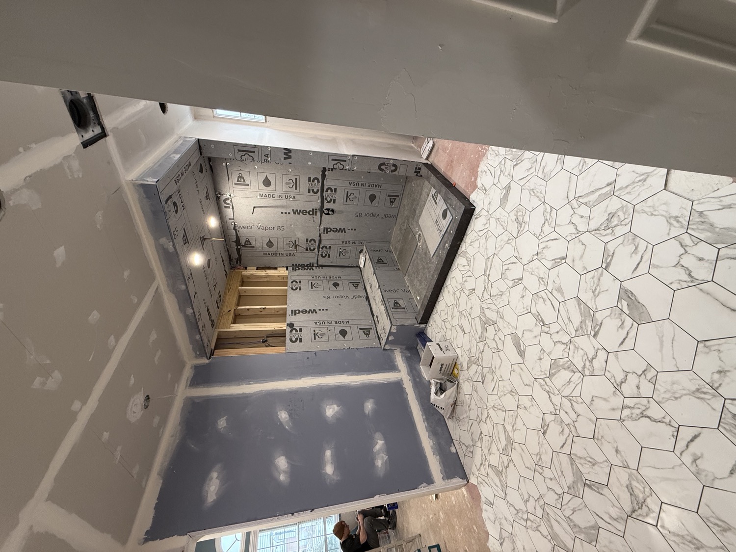Bathroom mid-build with waterproofing and subfloor