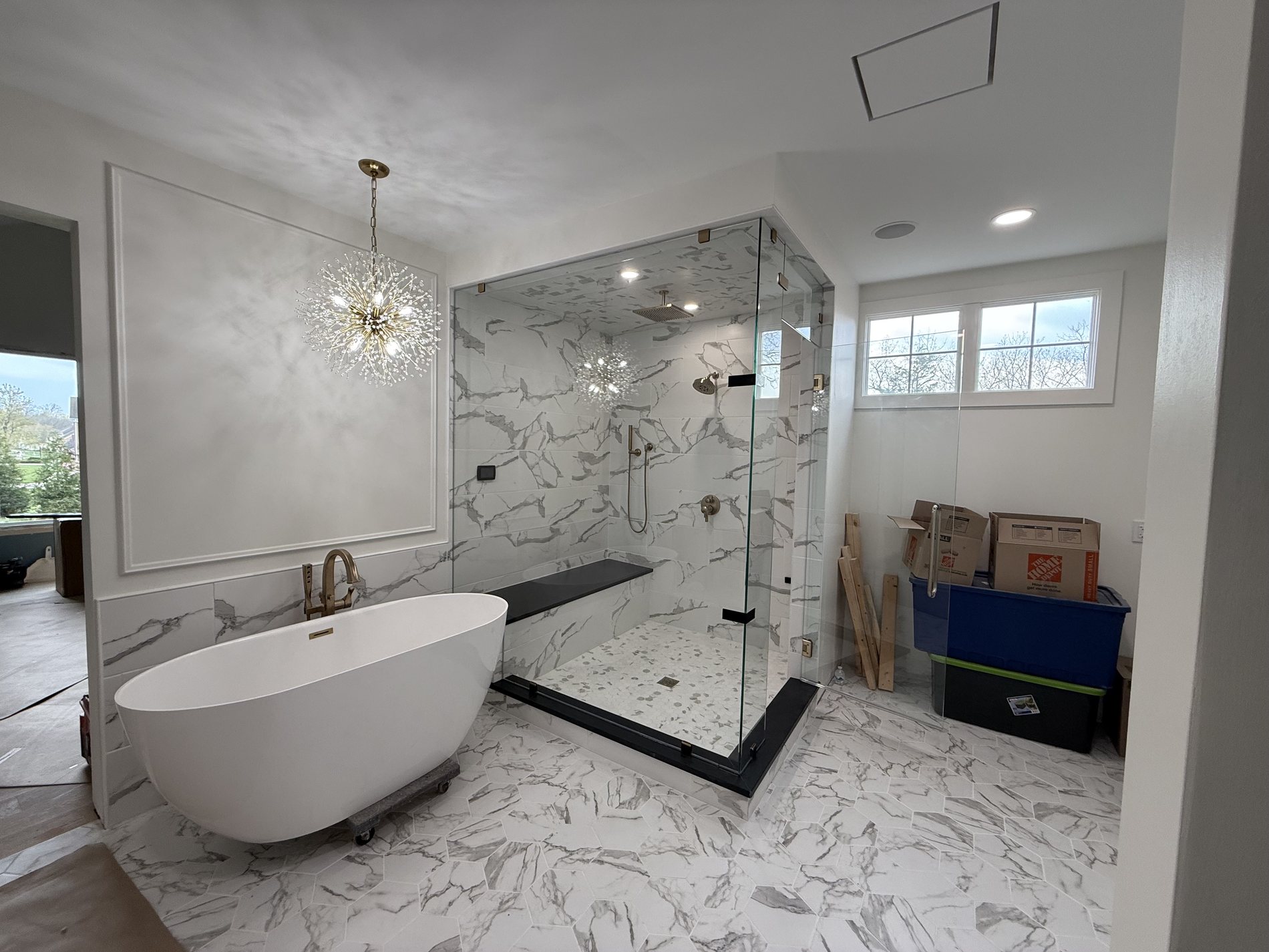 Marble master bathroom with freestanding tub and glass shower